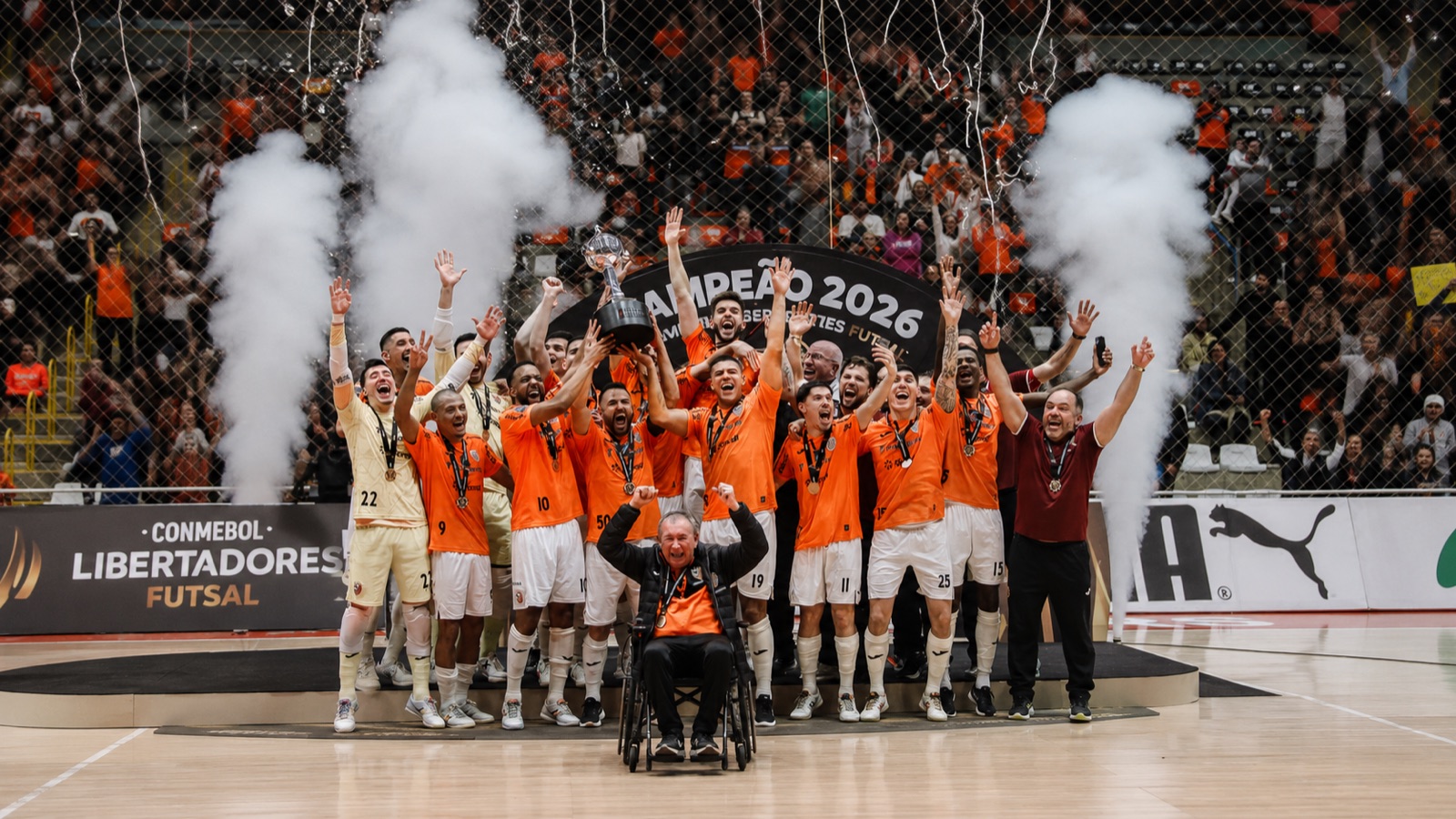 ACBF Carlos Barbosa campeã da Libertadores de Futsal 2026, time comemorando no pódio com pirotecnia